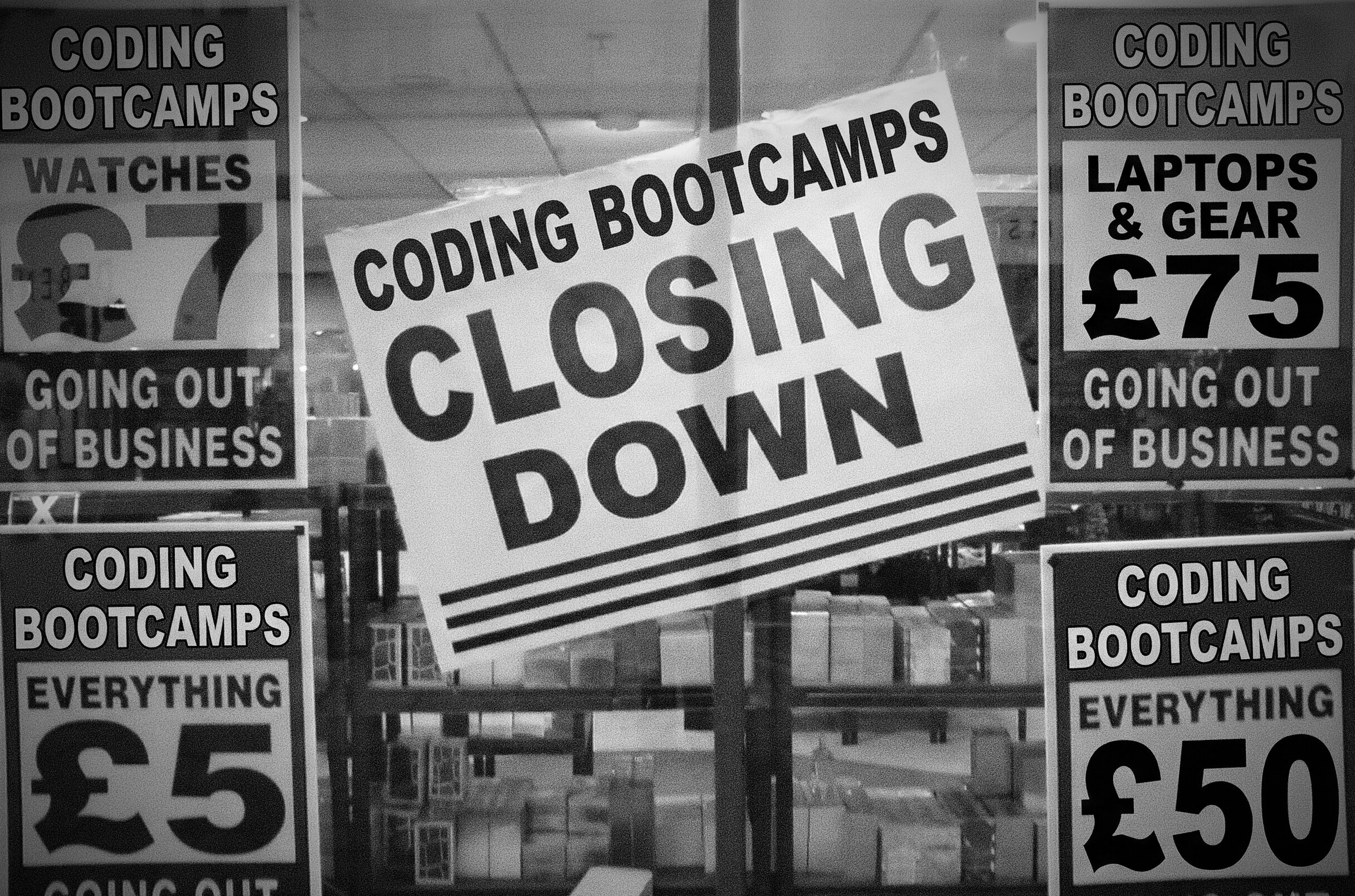 Black and white photograph of a store window displaying a large 'CODING BOOTCAMPS CLOSING DOWN' sign. Surrounding signs advertise clearance sales including 'WATCHES £7', 'LAPTOPS & GEAR £75', 'EVERYTHING £5', and 'EVERYTHING £50', all marked as 'GOING OUT OF BUSINESS'.